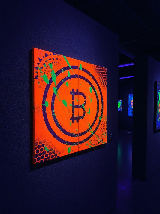 Vibrant orange and purple Bitcoin symbol artwork with circular abstract patterns displayed in dark gallery setting.