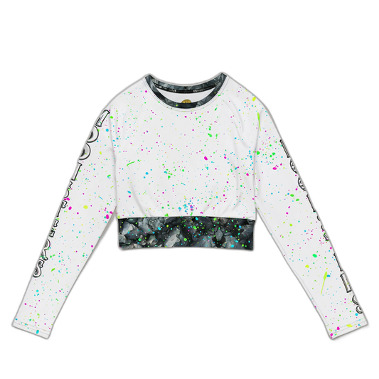 White cropped long-sleeve top with neon paint splatter and black marble-patterned hem and collar trim.