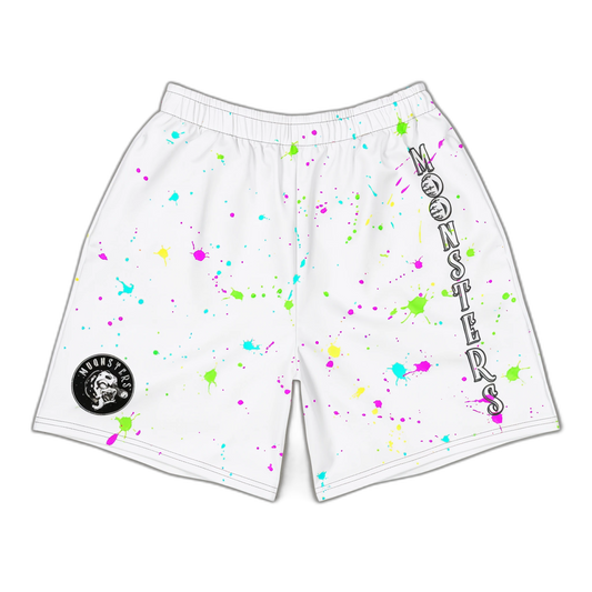 White shorts with neon paint splatters in pink, yellow, green, and blue, elastic waistband, and black circular logo patch on.