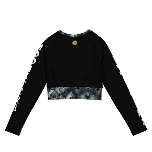 Black long sleeve crop top with white text on sleeves and marbled trim at hem and neckline.