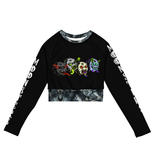 Black long sleeve crop top with colorful Moonsters designs and white text along sleeves.
