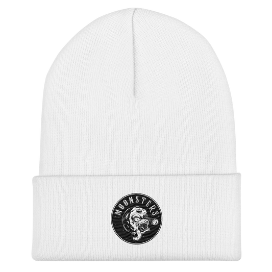 White knit beanie with folded cuff and black circular logo patch featuring a Moonsters design.